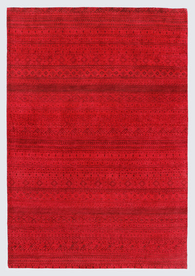 A full view of a vibrant, monochromatic crimson red wool rug featuring subtle, tone-on-tone horizontal bands of miniature Anatolian tribal motifs and geometric patterns.