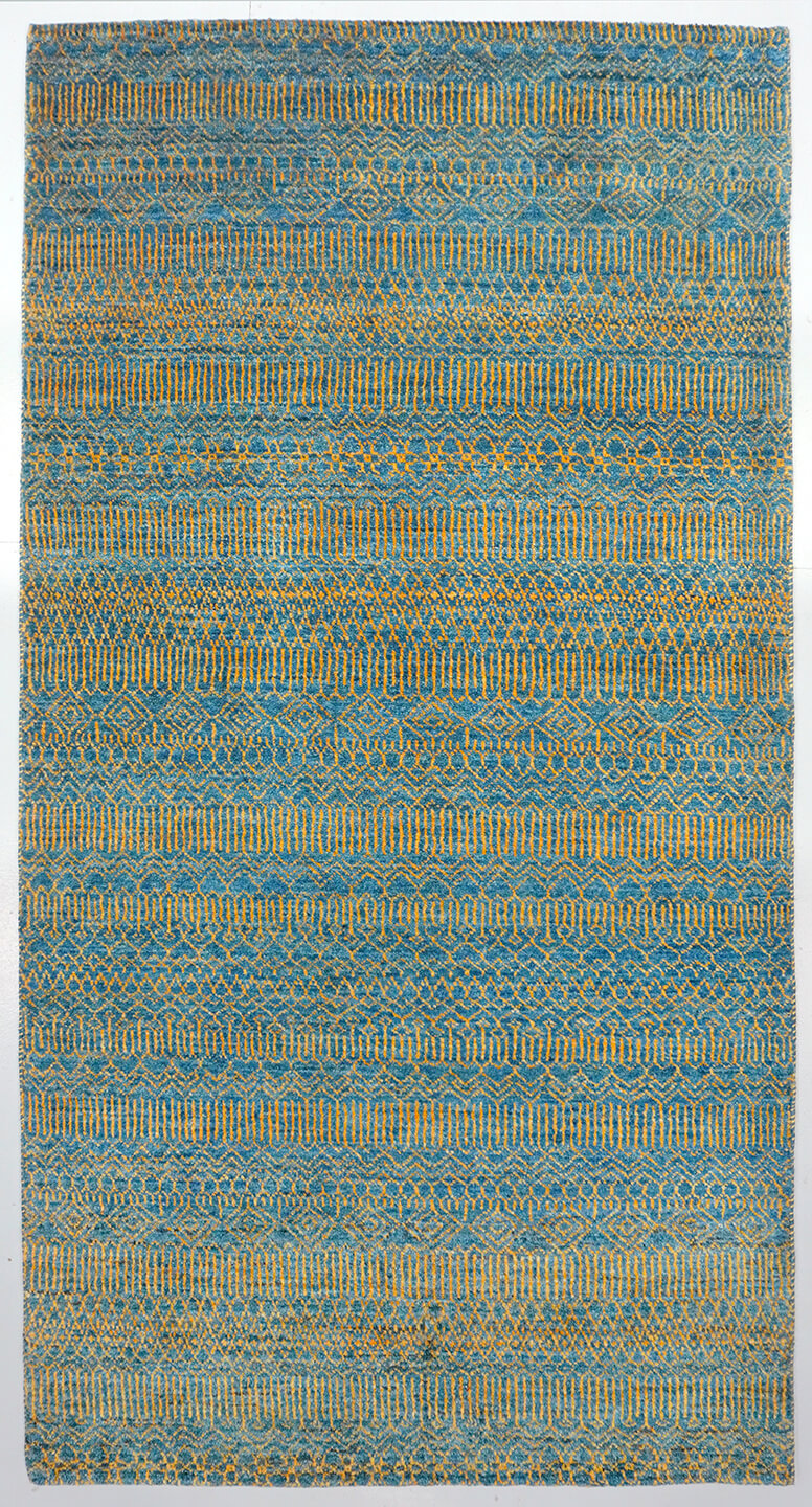Full view of an azure blue hand-knotted Aatish rug featuring rhythmic tiers of golden Qila motifs