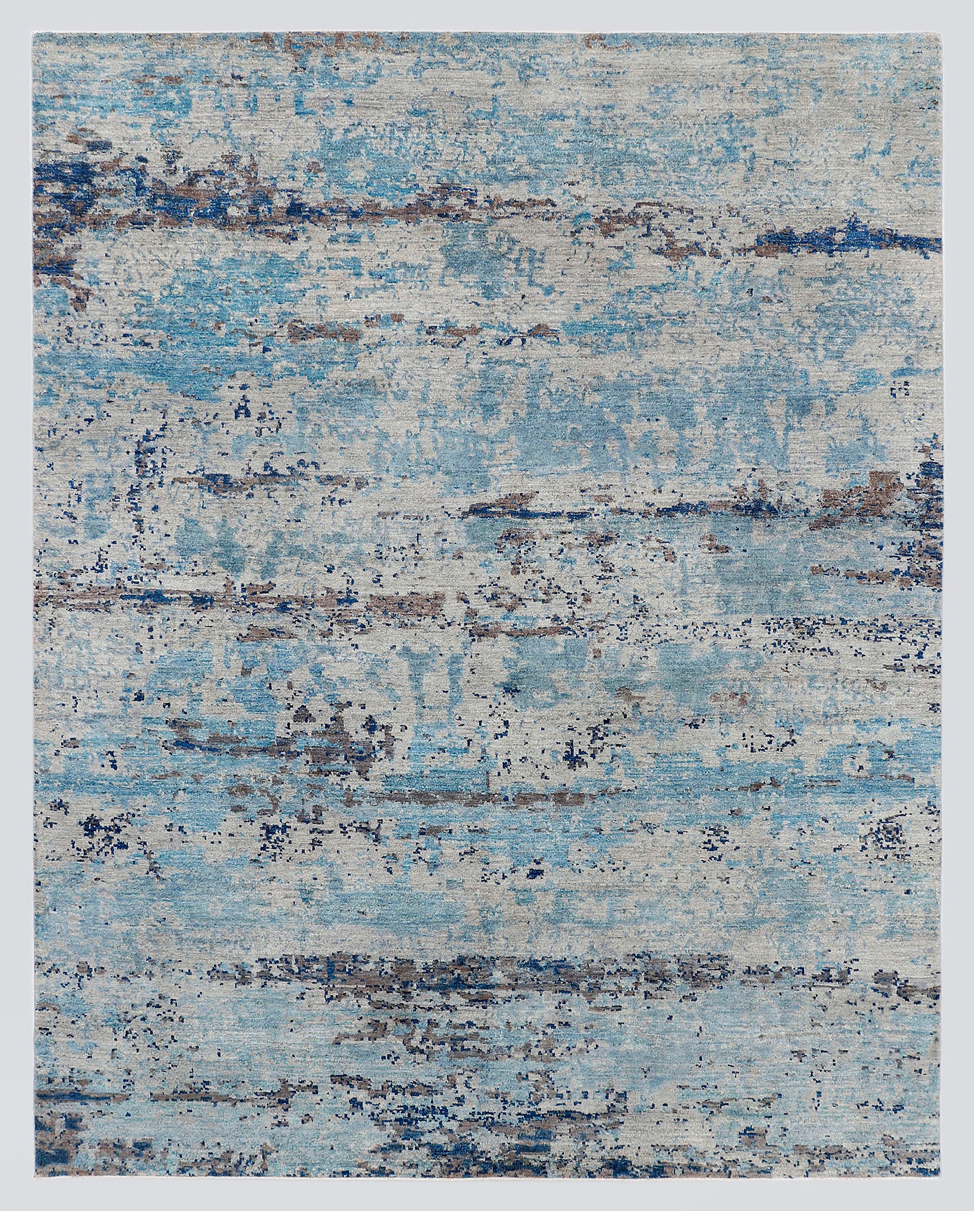 A full view of a modern, pure abstract hand-knotted rug from the Fresco Edit, featuring sweeping, horizontal layers of frosty cerulean blue and deep indigo over a silvery-grey foundation.