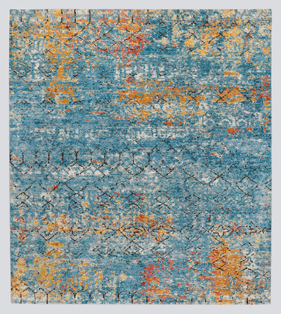 A full view of a modern transitional hand-knotted rug featuring a heavily distressed wash of lapis blue and fiery copper obscuring a classic nomadic geometric pattern.