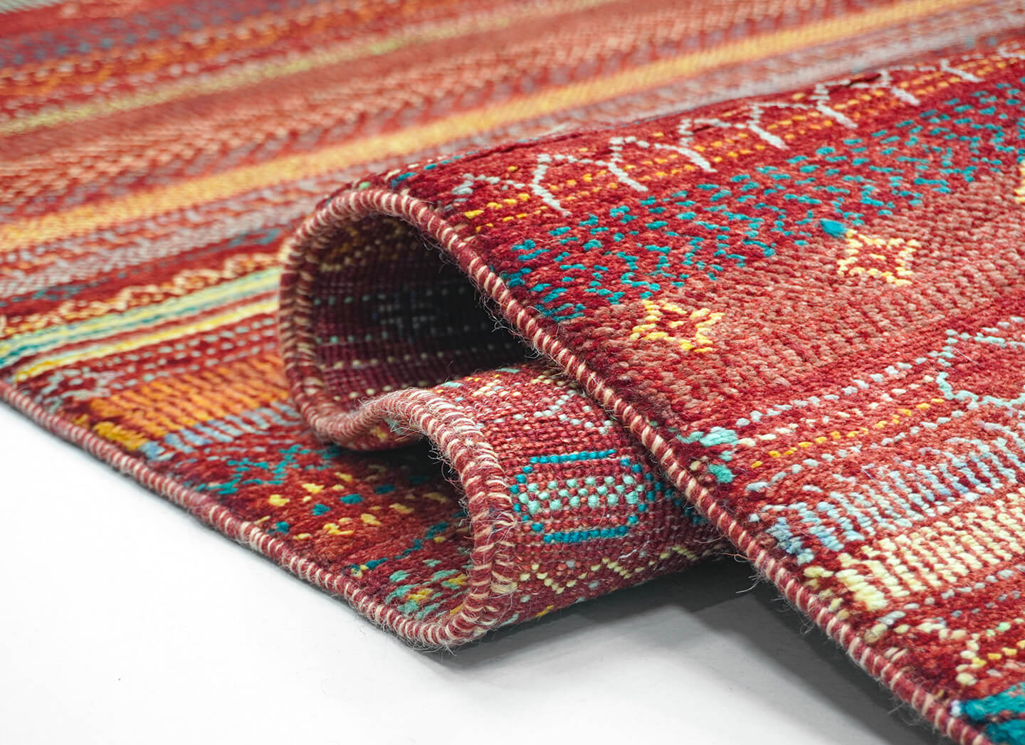 Close-up of the plush, Madder Rust wool pile and detailed heritage script levels of the Madder Khat rug.
