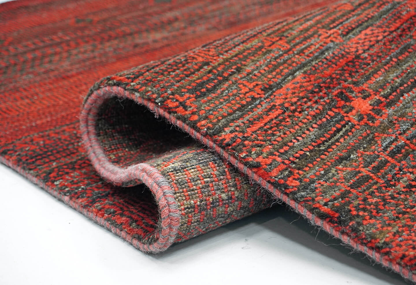 Close-up of the plush natural brown wool pile and detailed Madder rust heritage levels of the Madder Nazar rug