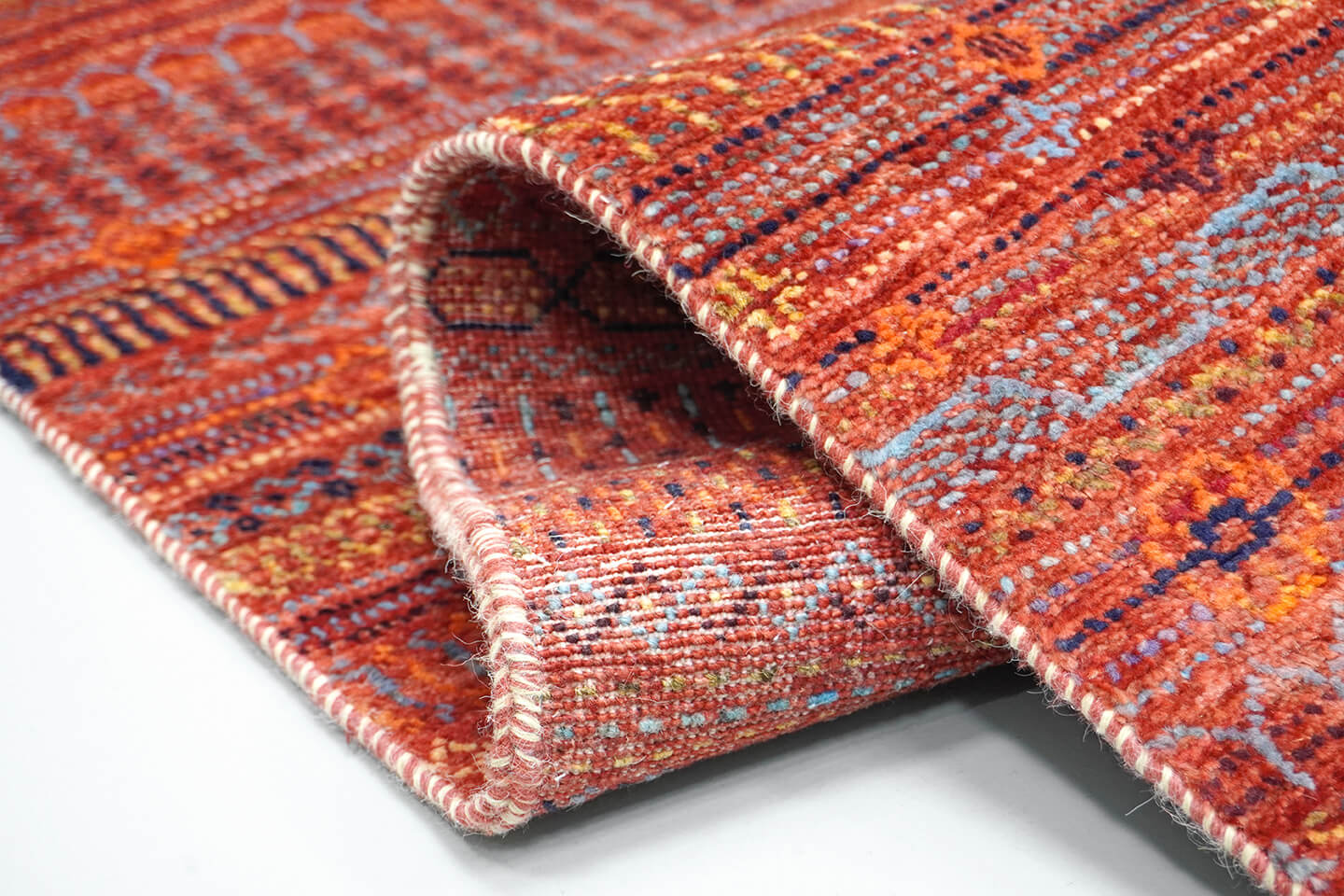 Close-up of the plush Madder Rust wool pile and detailed heritage Tarh levels