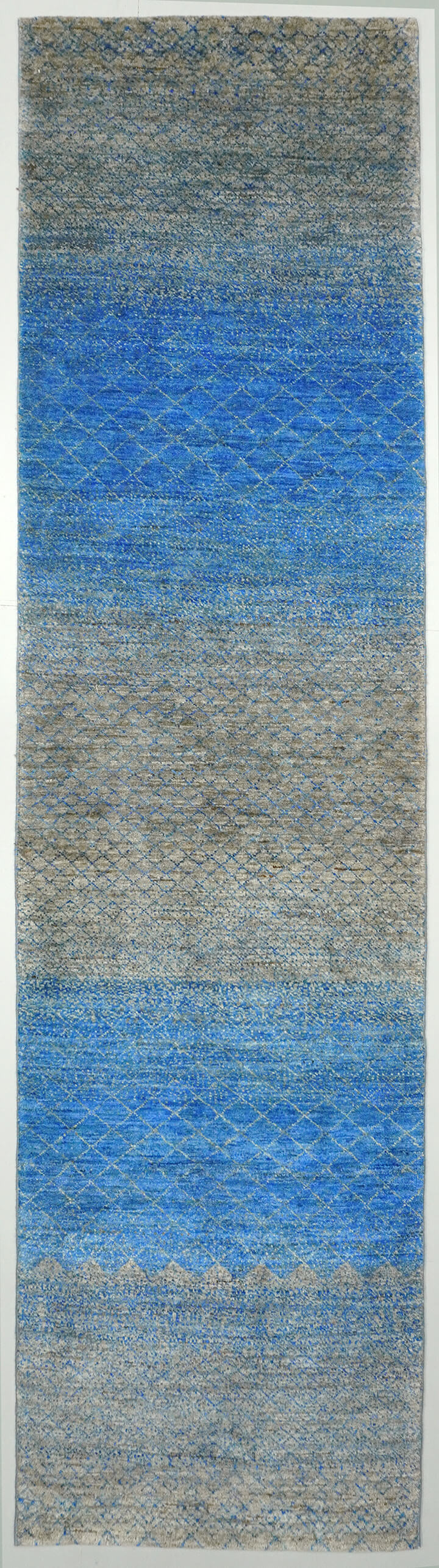 Full view of a multi-tonal natural grey and brown hand-knotted Aatish rug featuring blue tie-and-dye motifs