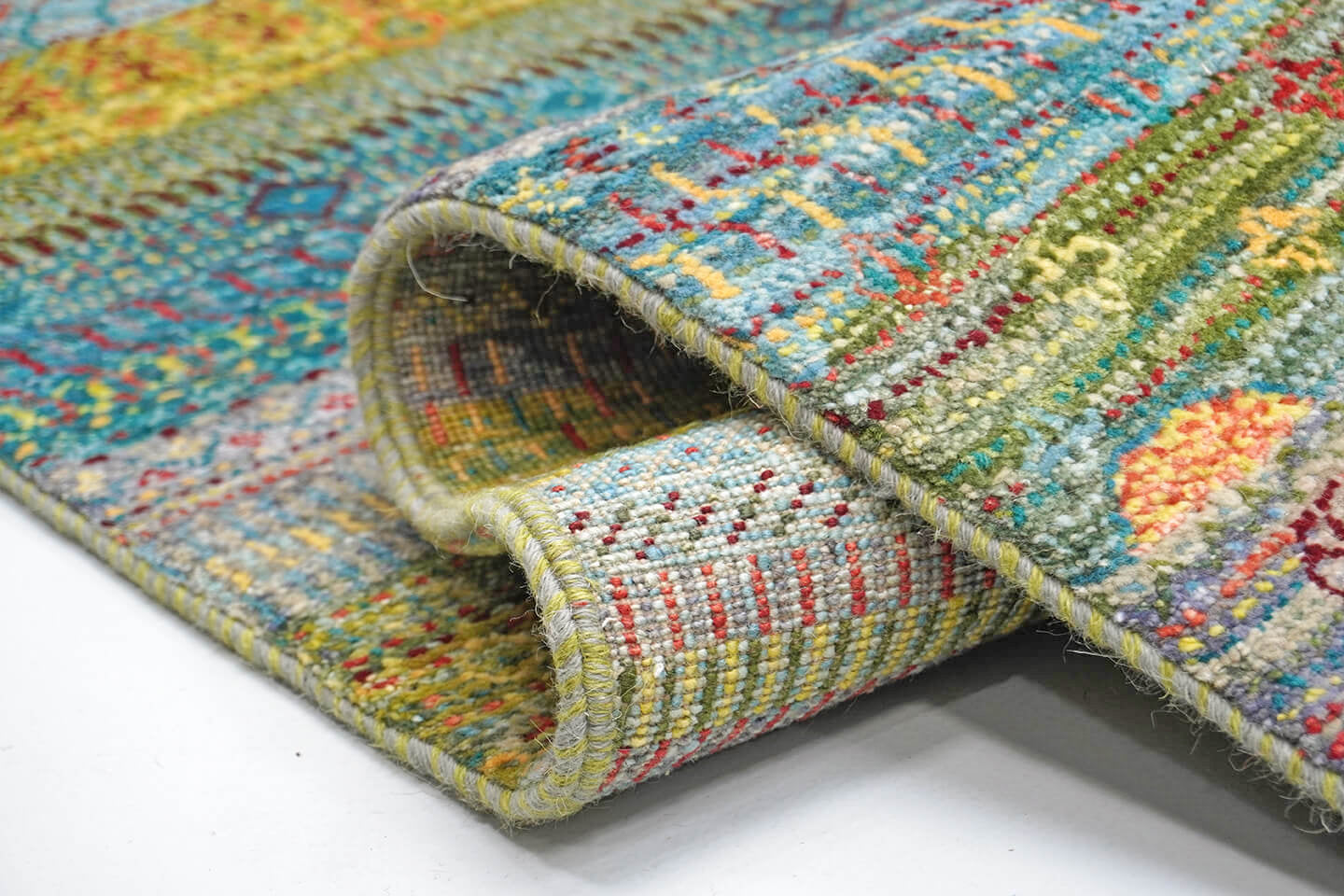 Close-up of the plush multi-tonal wool pile and detailed heritage statement levels of the Opal Baya rug.