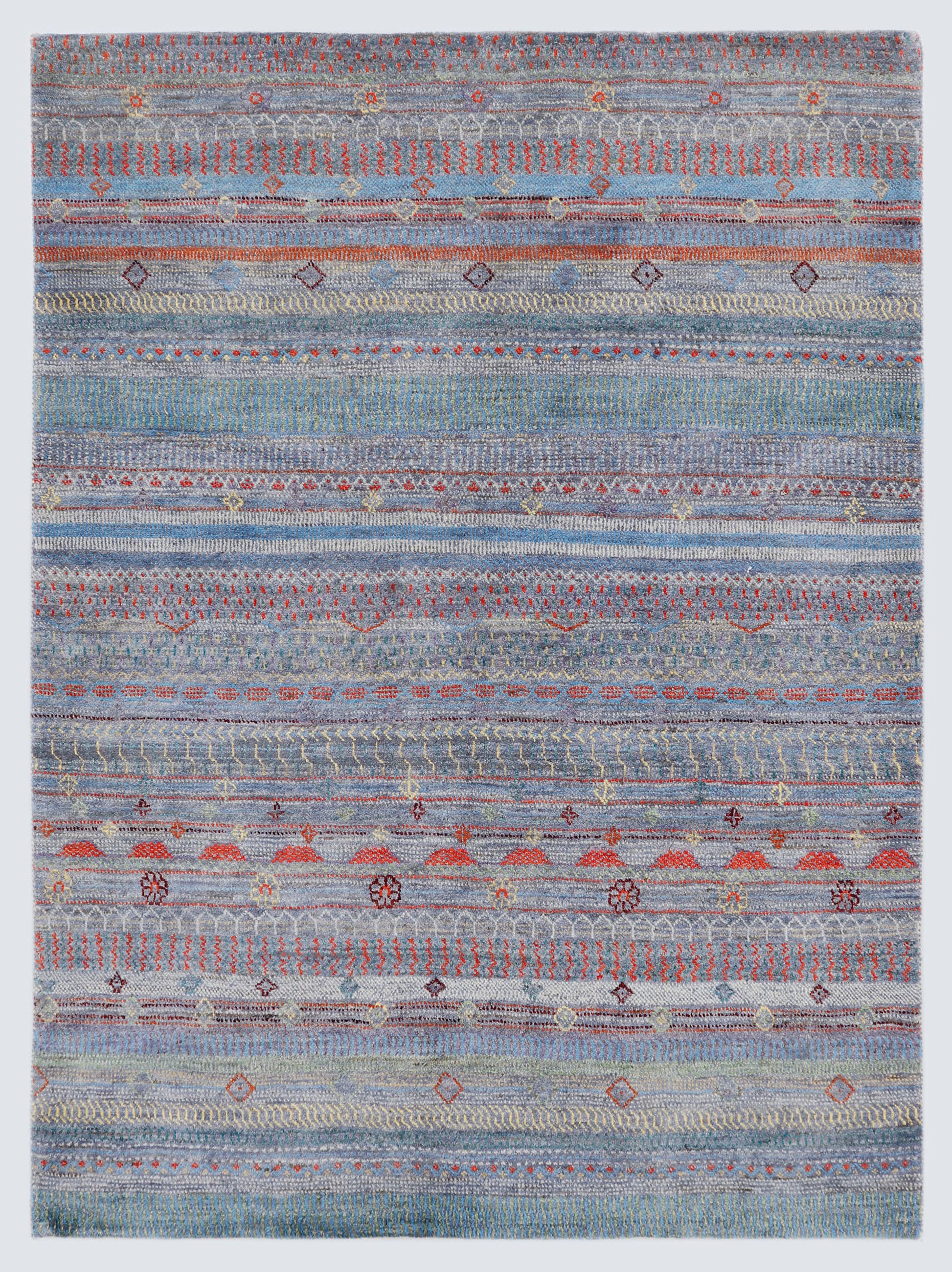A full view of a hand-knotted wool rug featuring dense horizontal bands of miniature tribal motifs in terracotta and olive against a silver-grey foundation.