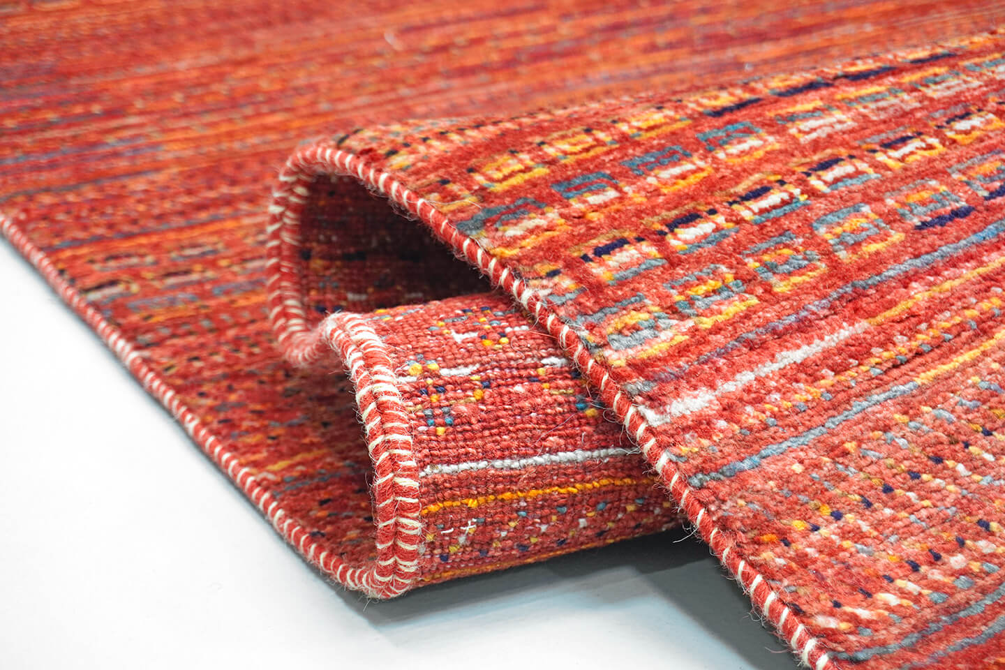 Close-up of the plush, hand-knotted wool pile and detailed sienna levels of the Sienna Nakshe rug.