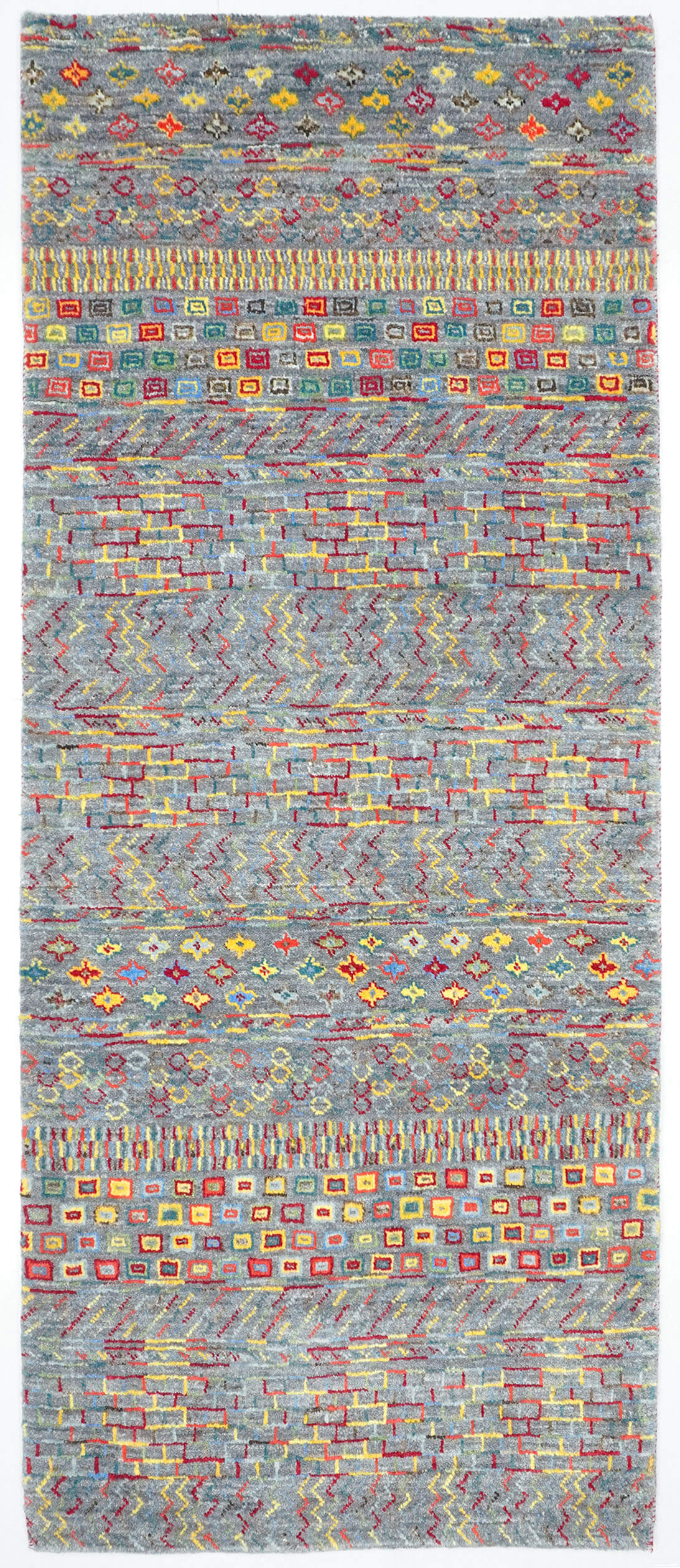 Full view of a silver grey hand-knotted Aatish rug featuring rhythmic levels of multi-colored Tariqa motifs