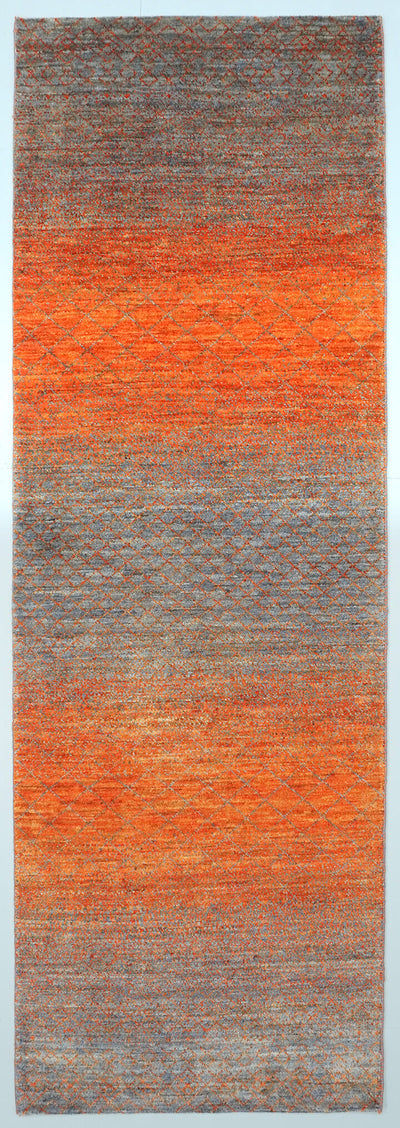 Full view of a slate grey hand-knotted Aatish rug featuring vibrating orange color transitions.