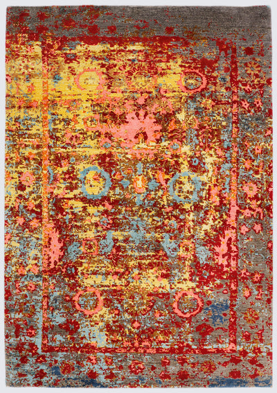 A full view of a hand-knotted transitional rug featuring a natural, textured undyed brown base, overlaid with distressed classical floral borders and a vibrant wash of crimson, sunlit yellow, and oxidized aqua blue.