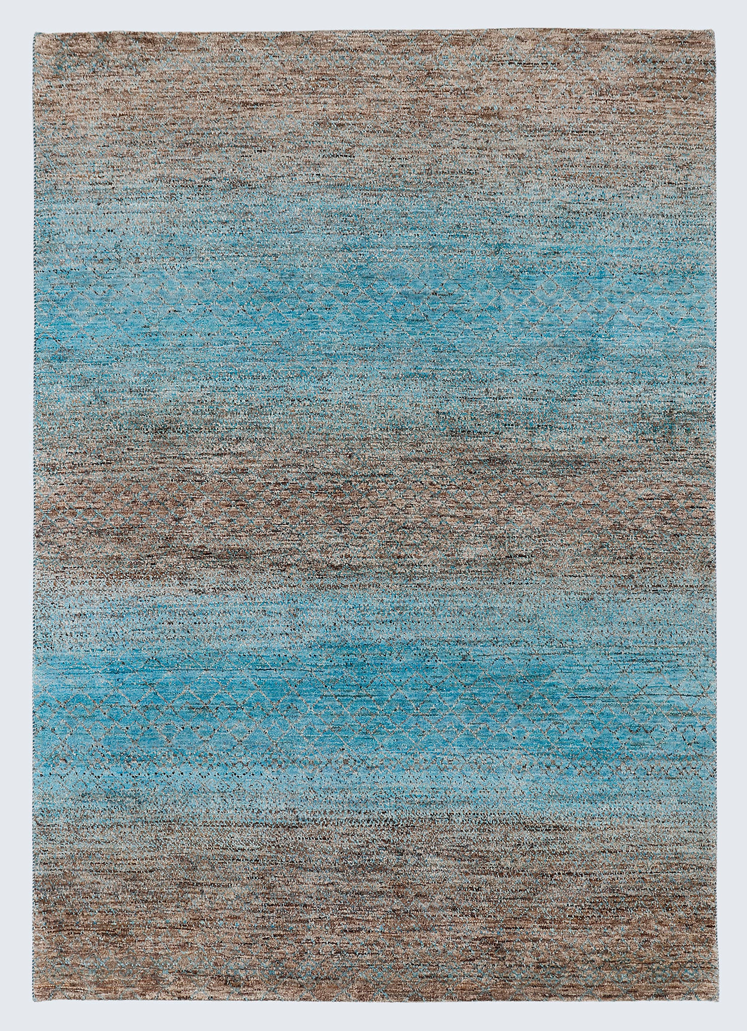 A full architectural view of a large hand-knotted Aatish Gabbeh rug featuring horizontal sea-blue and ochre bands over a raw, un-dyed natural brown wool foundation.
