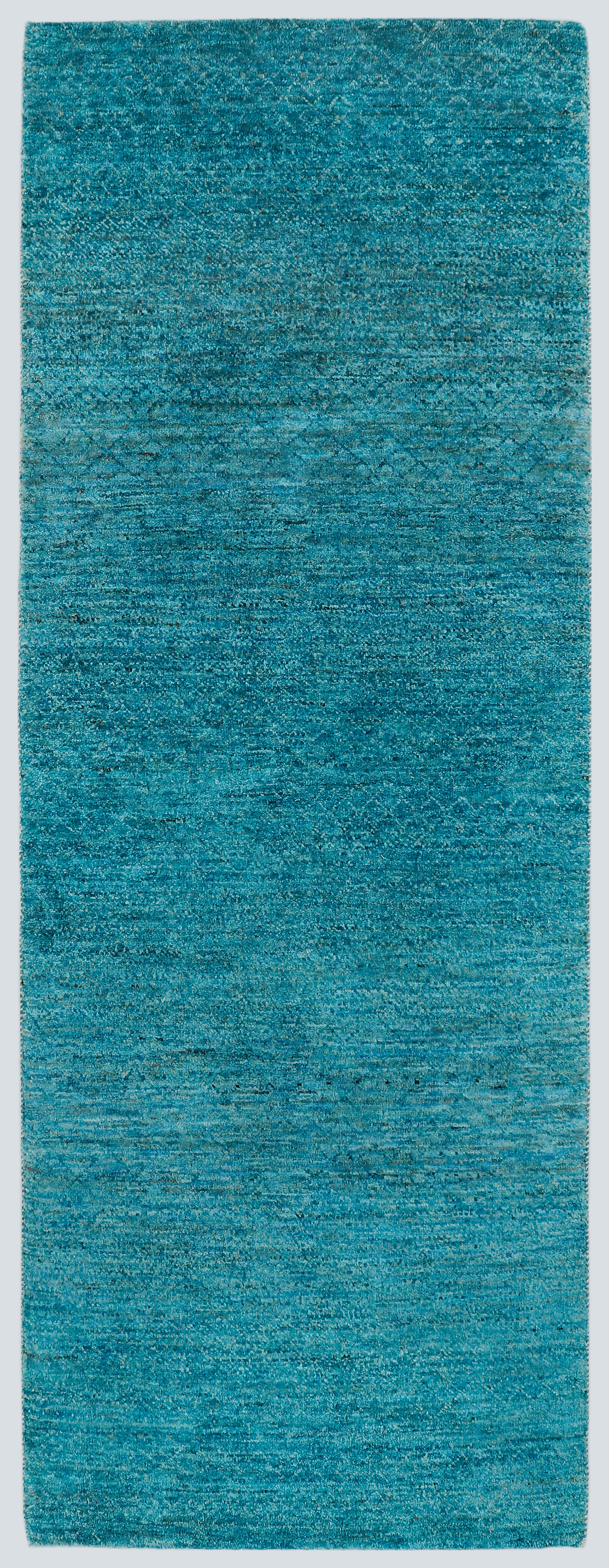 A full view of a vibrant, sea-blue-green hand-knotted double-knot Gabbeh rug, showing the horizontal tonal shifts and rich texture of the Aatish collection.