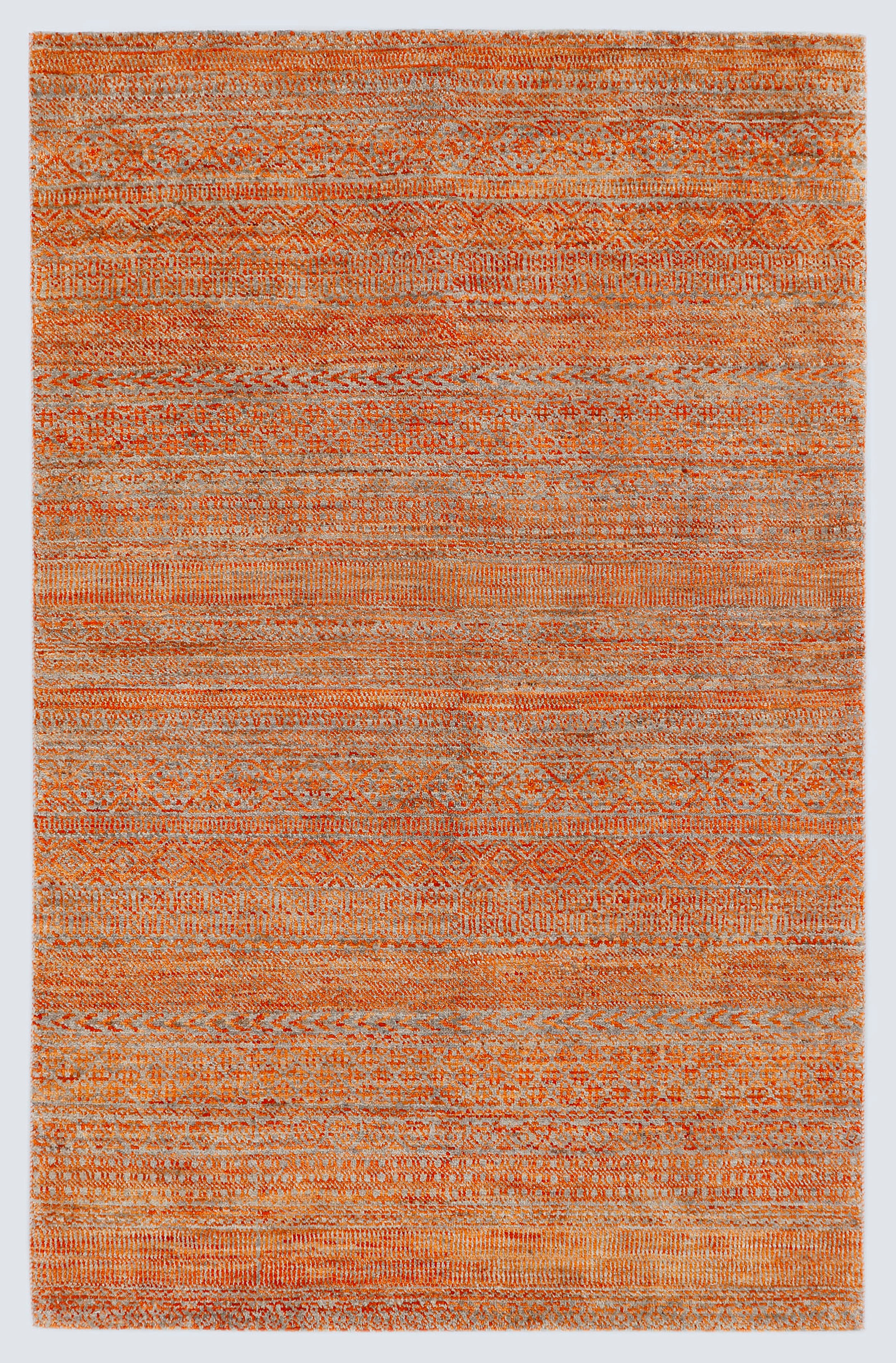A full architectural view of a high-density hand-knotted Aatish Gabbeh rug featuring rhythmic bands of variegated orange motifs over a shimmering silver-grey foundation.