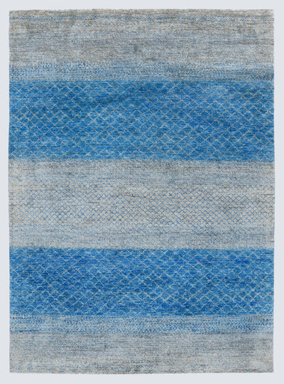 A full view of a large, high-density hand-knotted Aatish rug with horizontal bands of saturated blue over a multi-tonal silver-grey foundation.