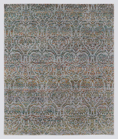 A full view of a modern transitional hand-knotted rug from the Nomad Series, featuring a repeating classical palmette pattern rendered in multi-colored, tie-dyed wool over a silvery-grey foundation.